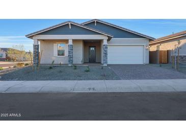 One-story home with gray exterior, stone accents, and a two-car garage at 13567 W Steed Ridge Rd, Peoria, AZ 85383