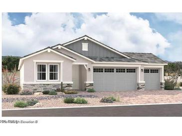 Two-story house with gray siding, stone accents, and a three-car garage at 11934 W Parkway Ln, Avondale, AZ 85323