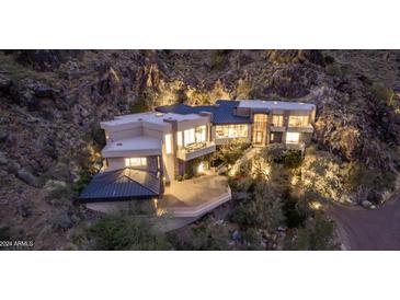 Luxury home nestled in the mountains with stunning city views at night at 5676 E Cheney Dr, Paradise Valley, AZ 85253