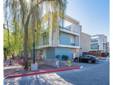 Modern building exterior with parking and landscaping at 520 S Roosevelt St # 1009, Tempe, AZ 85281