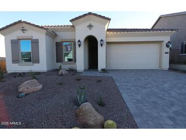 Inviting single-story home with desert landscaping, a two-car garage and a covered front entryway at 21369 W Hillcrest Blvd, Buckeye, AZ 85396