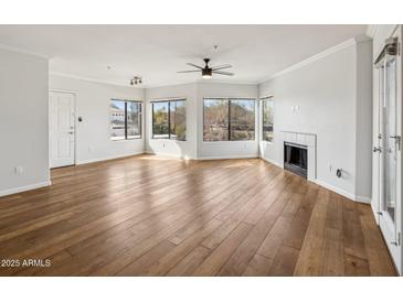 Spacious living room featuring hardwood floors and a fireplace at 7575 E Indian Bend Rd # 2081, Scottsdale, AZ 85250