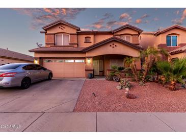Charming two-story home featuring a well-maintained yard with desert landscaping and a two-car garage at 14244 W Indianola Ave, Goodyear, AZ 85395