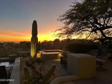 Desert landscape with spa, seating area, and sunset view at 41504 N 107Th Way, Scottsdale, AZ 85262