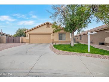 Single-story home with attached garage and landscaped front yard at 14727 N Gil Balcome N Ct, Surprise, AZ 85379