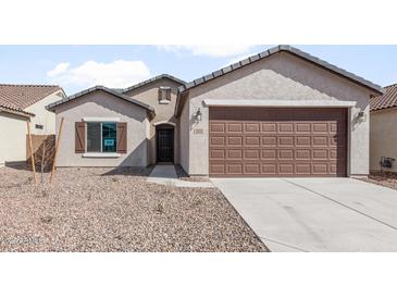 Charming single-story home featuring a two-car garage and low maintenance desert landscaping at 2851 N Coronado Dr, Florence, AZ 85132