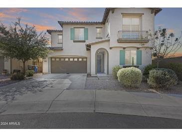 Two-story home with gray exterior, teal accents, and a landscaped front yard at 130 N Bay Dr, Gilbert, AZ 85233