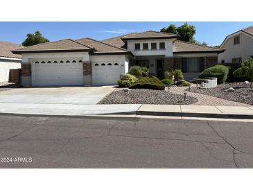 Single-story home with a three-car garage and landscaped front yard at 1187 E Tonto Dr, Chandler, AZ 85249