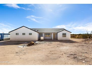 Newly constructed home with a modern design and desert landscape at 22750 E Roper Ln, Florence, AZ 85132