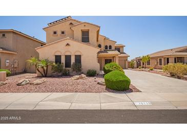 Two-story home with desert landscaping, solar panels, and a two-car garage at 15115 W Cottonwood St, Surprise, AZ 85374