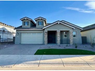 Charming single-story home features a manicured lawn and a two-car garage at 10015 W Verde Ln, Avondale, AZ 85392