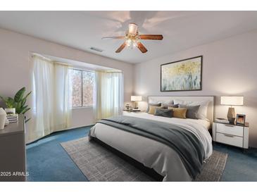 Spacious Primary bedroom with large window and ceiling fan at 19661 N Echo Rim Dr, Surprise, AZ 85387