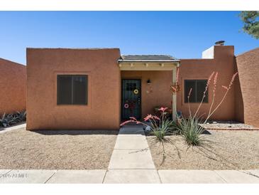 Charming home with a walkway leading to a covered front porch and decorative touches at 15601 N 27Th St # 7, Phoenix, AZ 85032
