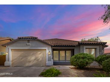 Single-story home with a two-car garage and landscaped front yard at 3365 E Aris Dr, Gilbert, AZ 85298