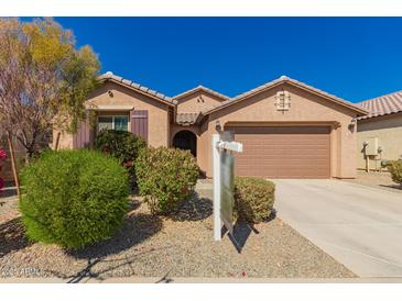 Charming single-story home with a well-maintained yard and a two-car garage, perfect for suburban living at 22882 E Marsh Rd, Queen Creek, AZ 85142