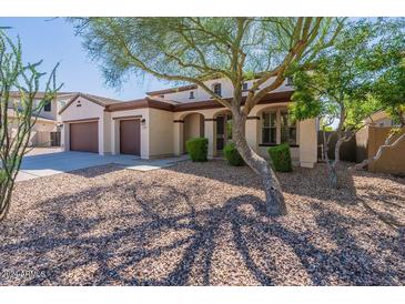 Two-story house with a three-car garage and desert landscaping at 42608 N 46Th Ave, New River, AZ 85087