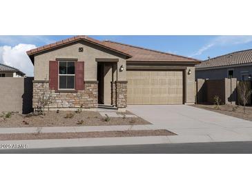 Charming single-story home featuring stone accents and a two-car garage, creating an inviting curb appeal at 18180 W Pima St, Goodyear, AZ 85338