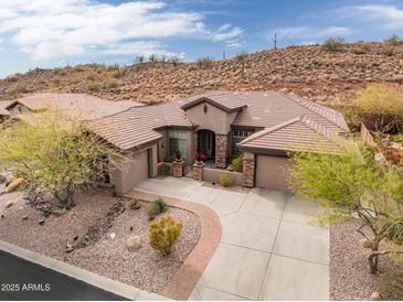 Attractive single-story home with Southwestern architecture, low maintenance desert landscaping, and tile roof at 41618 N Anthem Ridge Dr, Phoenix, AZ 85086