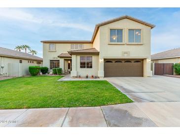 Two-story house with a brown door and landscaped lawn at 62 W Elmwood Pl, Chandler, AZ 85248