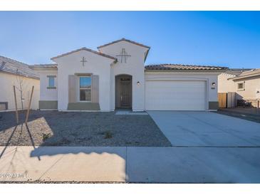 One-story home with white exterior, gray shutters, and a two-car garage at 16405 W Desert Mirage Dr, Surprise, AZ 85388