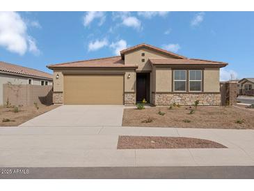 Charming single-story home with a two-car garage, desert landscaping, and a welcoming front entrance at 18168 W Pima St, Goodyear, AZ 85338