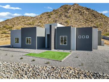 Modern home exterior boasts clean lines and a neutral color palette at 31559 N Pamela Dr, Queen Creek, AZ 85144