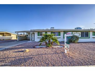 Charming single-story home featuring desert landscaping and solar panels for energy efficiency at 10619 W Clair Dr, Sun City, AZ 85351