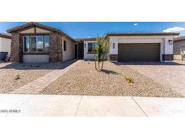 Charming single-story home with a gravel yard, brick accents, and a well-manicured lawn at 1329 W Via De Olivos Dr, San Tan Valley, AZ 85140