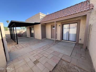 Private backyard with covered patio, storage shed, and block wall for added privacy at 205 E Loma Linda Blvd # 1, Avondale, AZ 85323