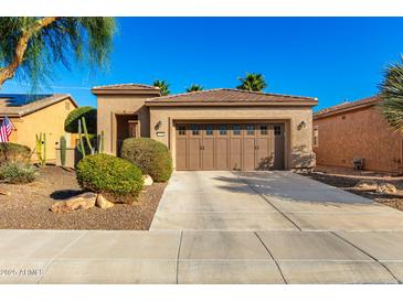 Charming home featuring a well-maintained front yard, desert landscaping, and an attached two-car garage at 12364 W Rosewood Ln, Peoria, AZ 85383