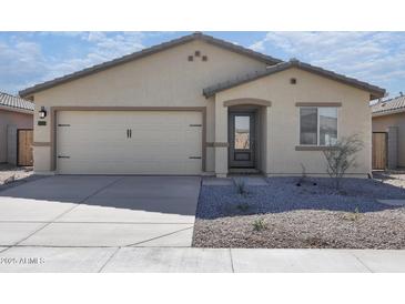Charming single-story home featuring a two-car garage, desert landscaping, and neutral color palette at 24579 W St Catherine Ave, Buckeye, AZ 85326