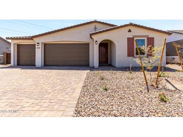 Inviting single-story home showcasing a well-manicured yard, covered entryway, and a two-car garage at 12333 W Marguerite Ave, Avondale, AZ 85323