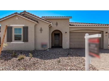 Inviting single-story home featuring a neutral stucco exterior, brown tile roof, and a well-maintained front yard at 11949 W Parkway Ln, Avondale, AZ 85323