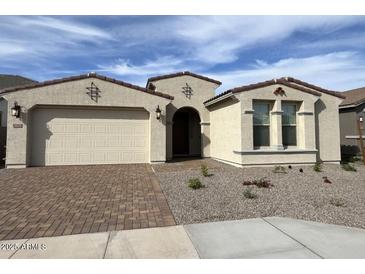 Inviting single-story home boasts a two-car garage, desert landscaping, and neutral color palette at 10262 W Columbus Ave, Avondale, AZ 85392