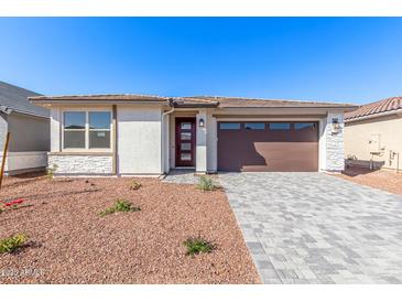 Charming single-story home featuring stone accents, a two-car garage and a well-manicured front yard at 5332 W Manzanita Dr, Glendale, AZ 85302