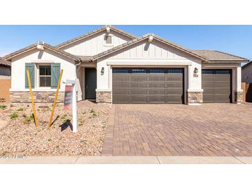Beautiful single-Gathering home with a two-car garage, desert landscaping, and a paved brick driveway at 12322 W Marguerite Ave, Avondale, AZ 85323