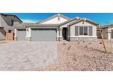 Charming single-story home with a three-car garage, stone accents, and low-maintenance landscaping at 12314 W Marguerite Ave, Avondale, AZ 85323