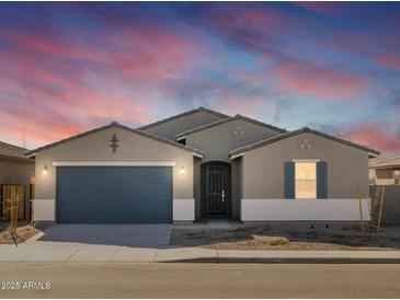 Single-story home with two-car garage and desert landscaping at 36833 W La Paz St, Maricopa, AZ 85138