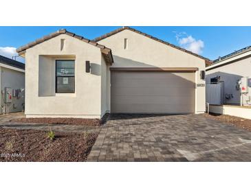 Single Gathering home featuring a neutral color palette, a two-car garage, and a nicely paved driveway at 4430 N 203Rd Dr, Buckeye, AZ 85396