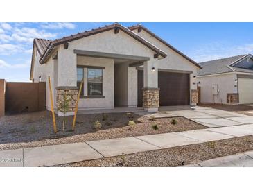 Charming single-story home with a two-car garage and desert landscaping at 16625 N Lunar St, Maricopa, AZ 85138