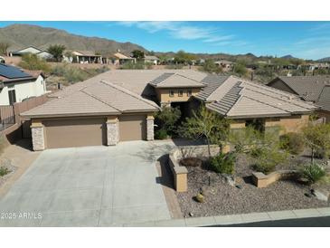 Single-story home with tile roof, large driveway, and desert landscaping at 42023 N Bridlewood Way, Phoenix, AZ 85086