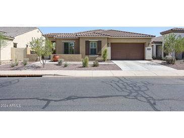 One-story home with tile roof, shutters, and attached garage at 14133 S 179Th Ave, Goodyear, AZ 85338