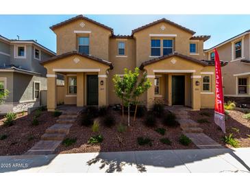 Inviting two-story home showcasing stylish elevations, desert landscaping, and private entrances at 2878 N Evergreen St, Buckeye, AZ 85396