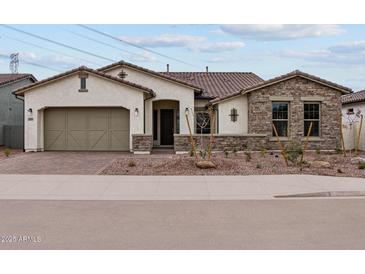 Beautiful single-story home with a brick-paved walkway and meticulously landscaped front yard at 12315 W Parkway Ln, Avondale, AZ 85323