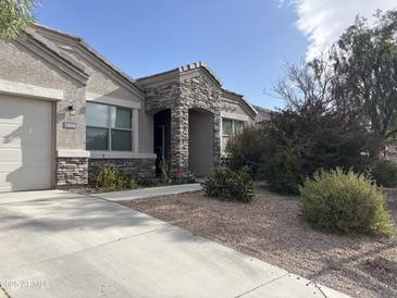 One-story home with stone accents and a landscaped front yard at 30346 W Columbus Ave, Buckeye, AZ 85396