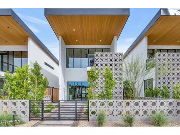 Contemporary home showcasing a striking modern design with clean lines, geometric facade, and wood-clad ceiling at 6914 E 2Nd St, Scottsdale, AZ 85251
