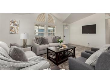 Inviting living room with plush seating, stylish decor, and bright natural light from the large windows at 2233 E Behrend Dr # 210, Phoenix, AZ 85024