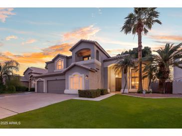 Beautiful two-story home featuring a well-maintained lawn, mature palm trees, and a grand entryway at 760 N Ithica St, Gilbert, AZ 85233