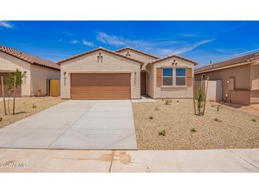 Charming single-story home showcasing a desert landscape, neutral colors, and a two-car garage at 18156 W Cielo Grande Ave, Surprise, AZ 85387