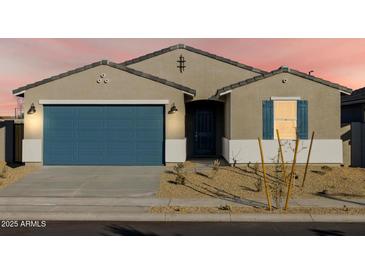 One-story house with blue garage door, landscaping, and light-colored exterior at 22550 W Tonopah Dr, Surprise, AZ 85387